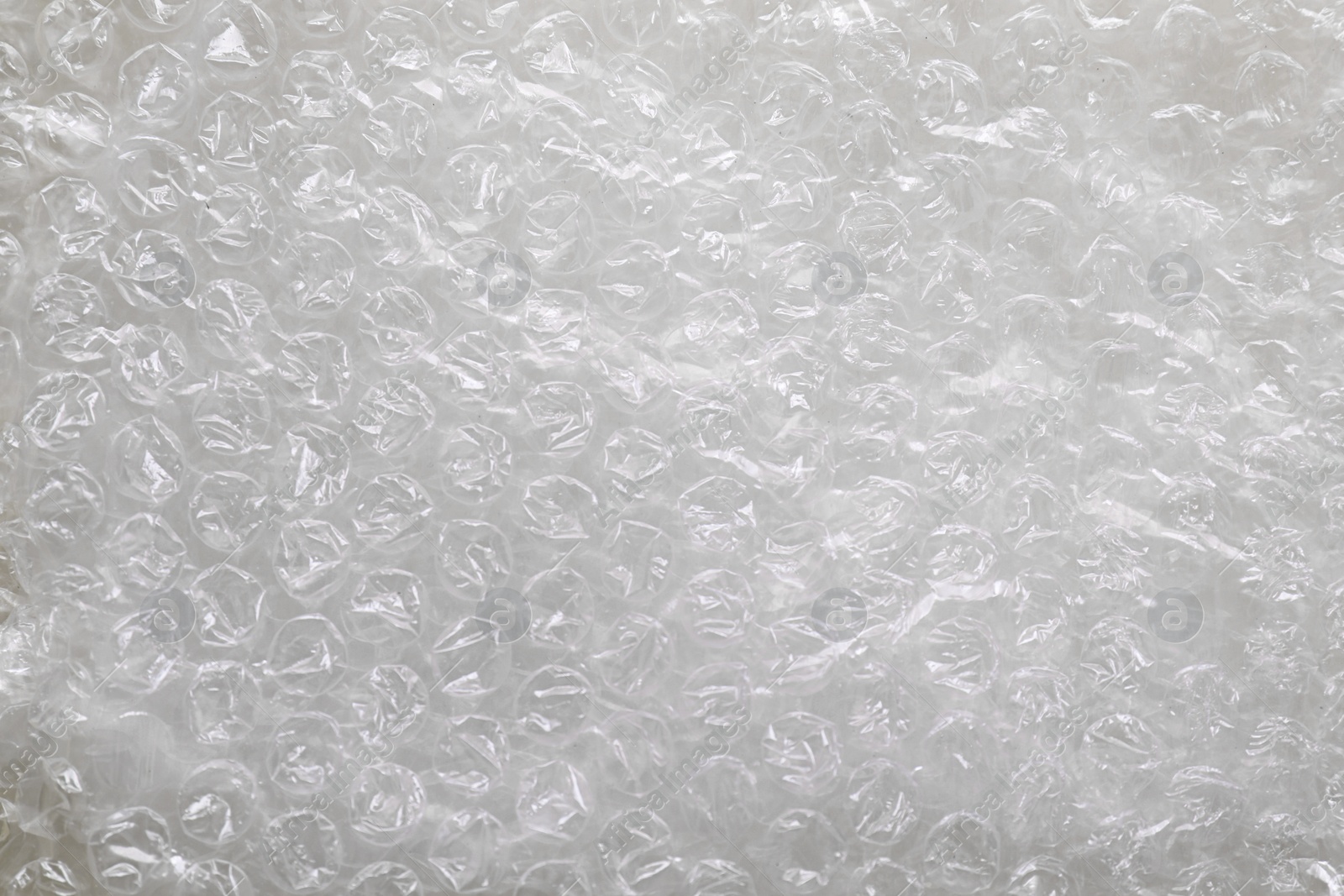 Photo of Transparent bubble wrap as background, top view