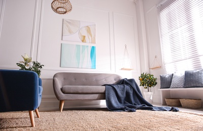 Beautiful living room interior with comfortable gray sofa