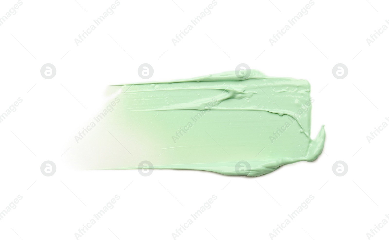 Photo of Strokes of green color correcting concealer isolated on white, top view