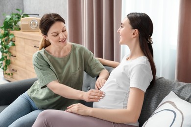 Doula taking care of pregnant woman at home. Preparation for child birth