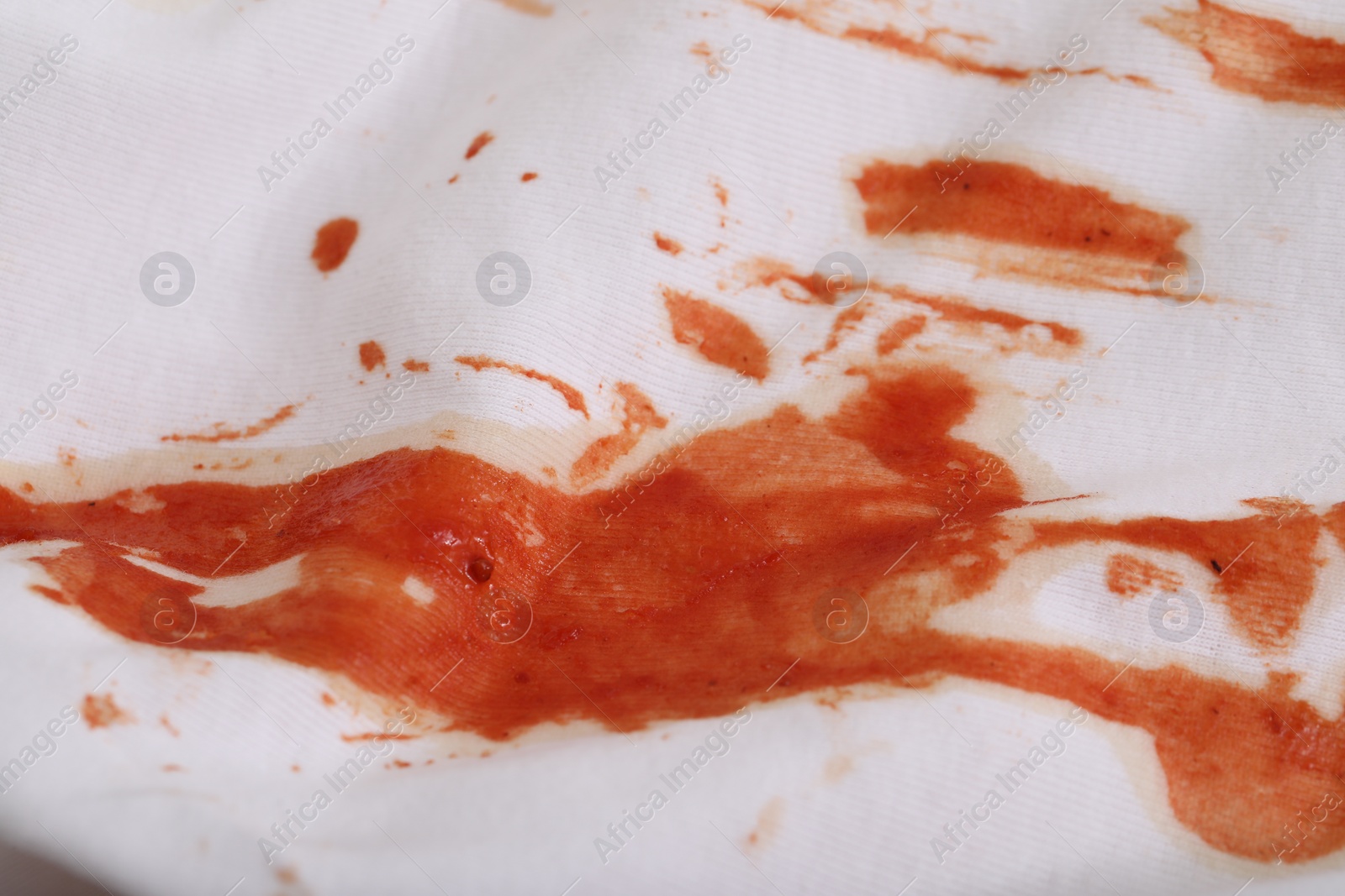 Photo of White shirt with stain of sauce, closeup