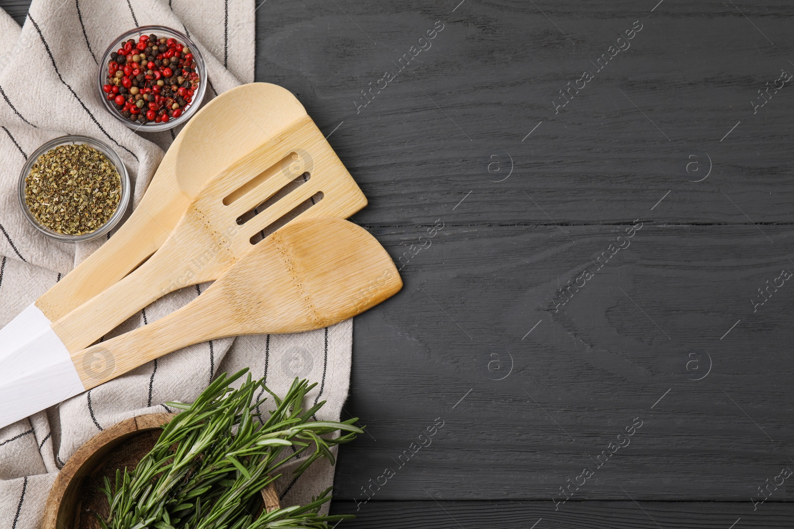 Photo of Set of different kitchen utensils and spices on grey wooden table, flat lay. Space for text