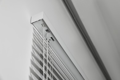 Photo of Closeup view of horizontal blinds on window indoors