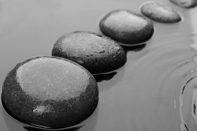 Photo of Beautiful spa stones in water. Zen lifestyle