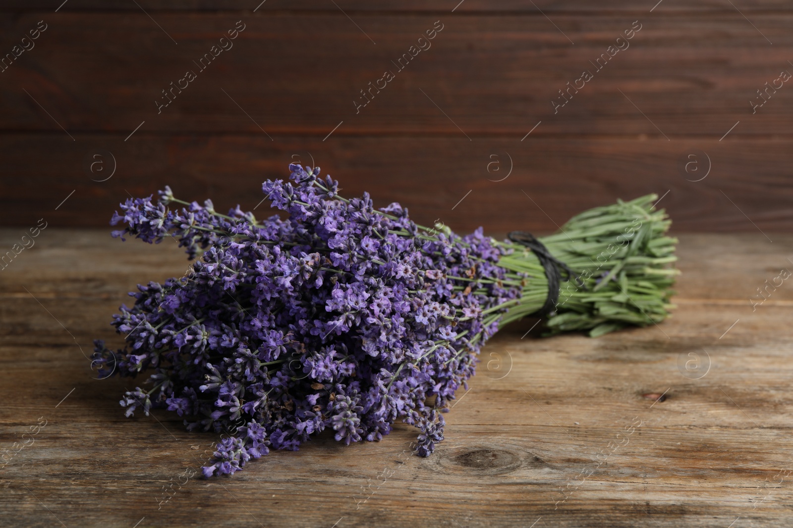 Photo of Beautiful fresh lavender bouquet on wooden table