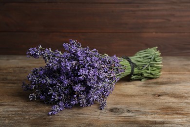 Beautiful fresh lavender bouquet on wooden table