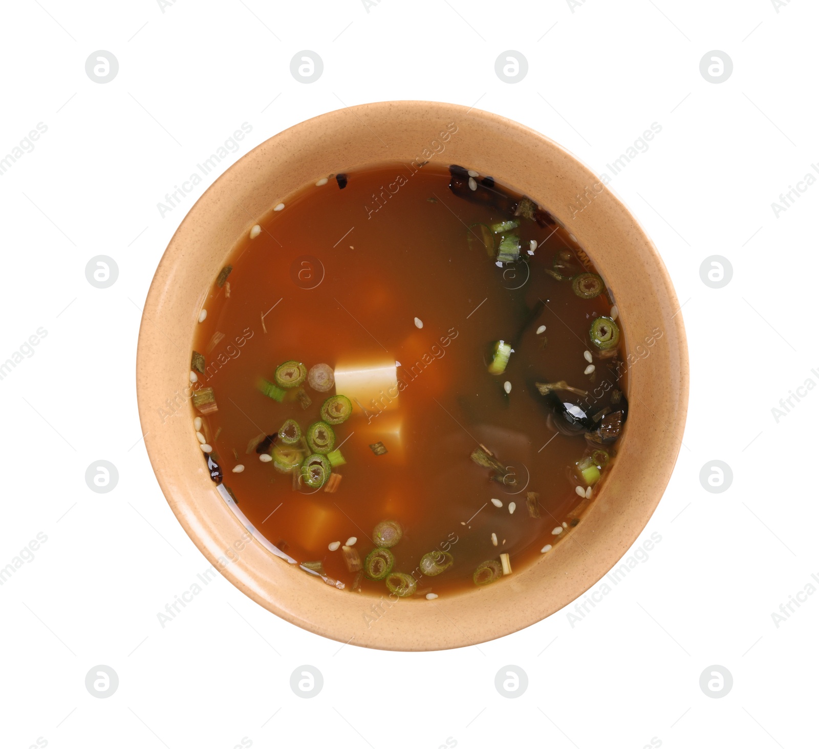 Photo of Bowl of delicious miso soup with tofu isolated on white, top view