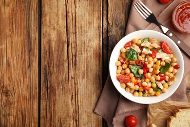 Photo of Delicious fresh chickpea salad served on wooden table