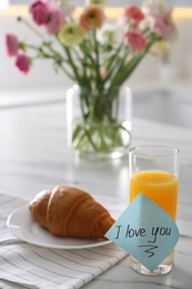 Romantic breakfast with note saying I Love You on table