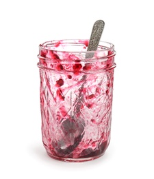 Leftovers of tasty sweet jam in glass jar on white background