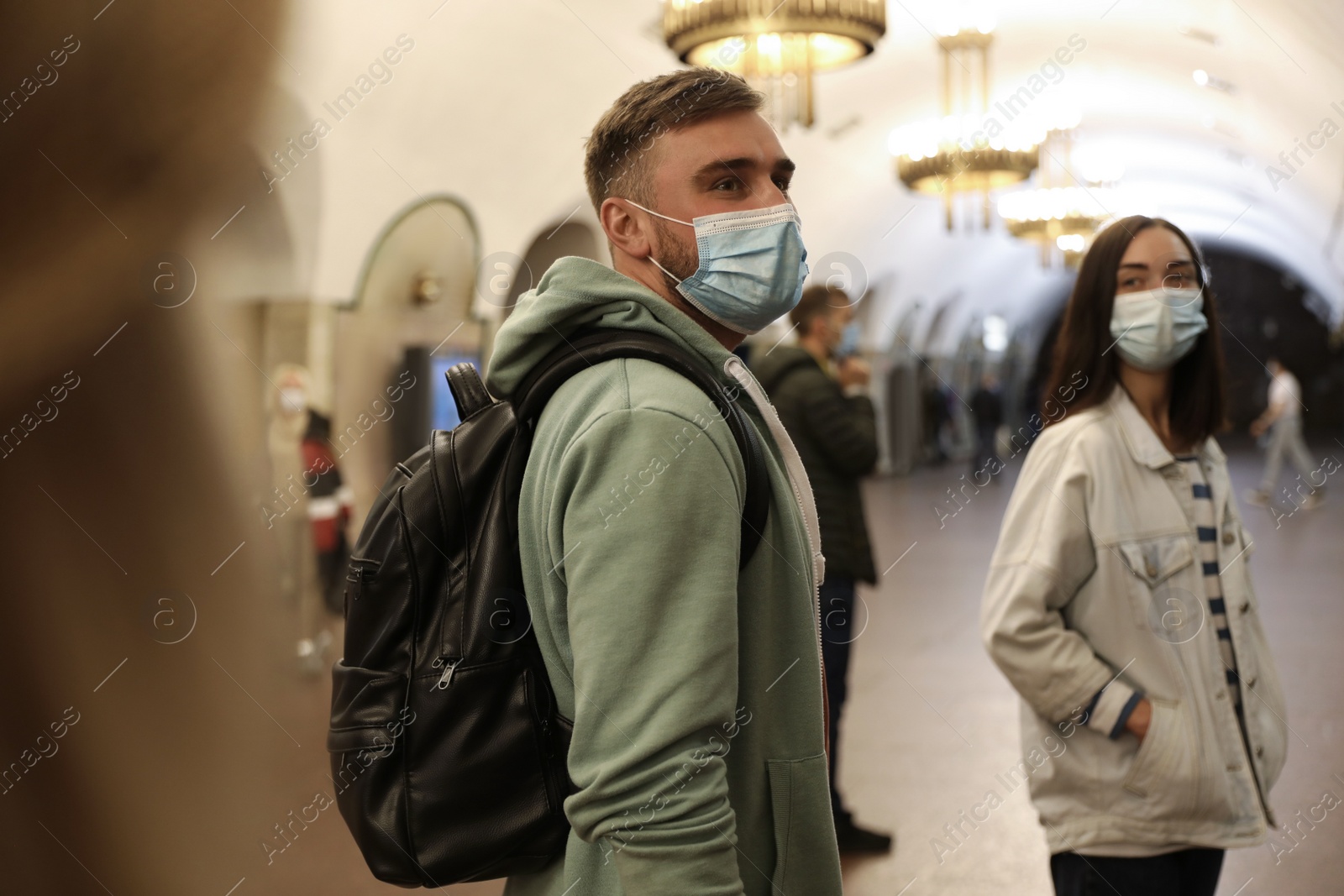 Photo of People in protective masks at subway station. Public transport