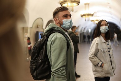 Photo of People in protective masks at subway station. Public transport
