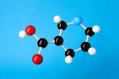 Photo of Molecule of vitamin B3 on light blue background. Chemical model