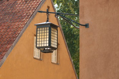 Photo of Beautiful vintage street lamp hanging on wall of building