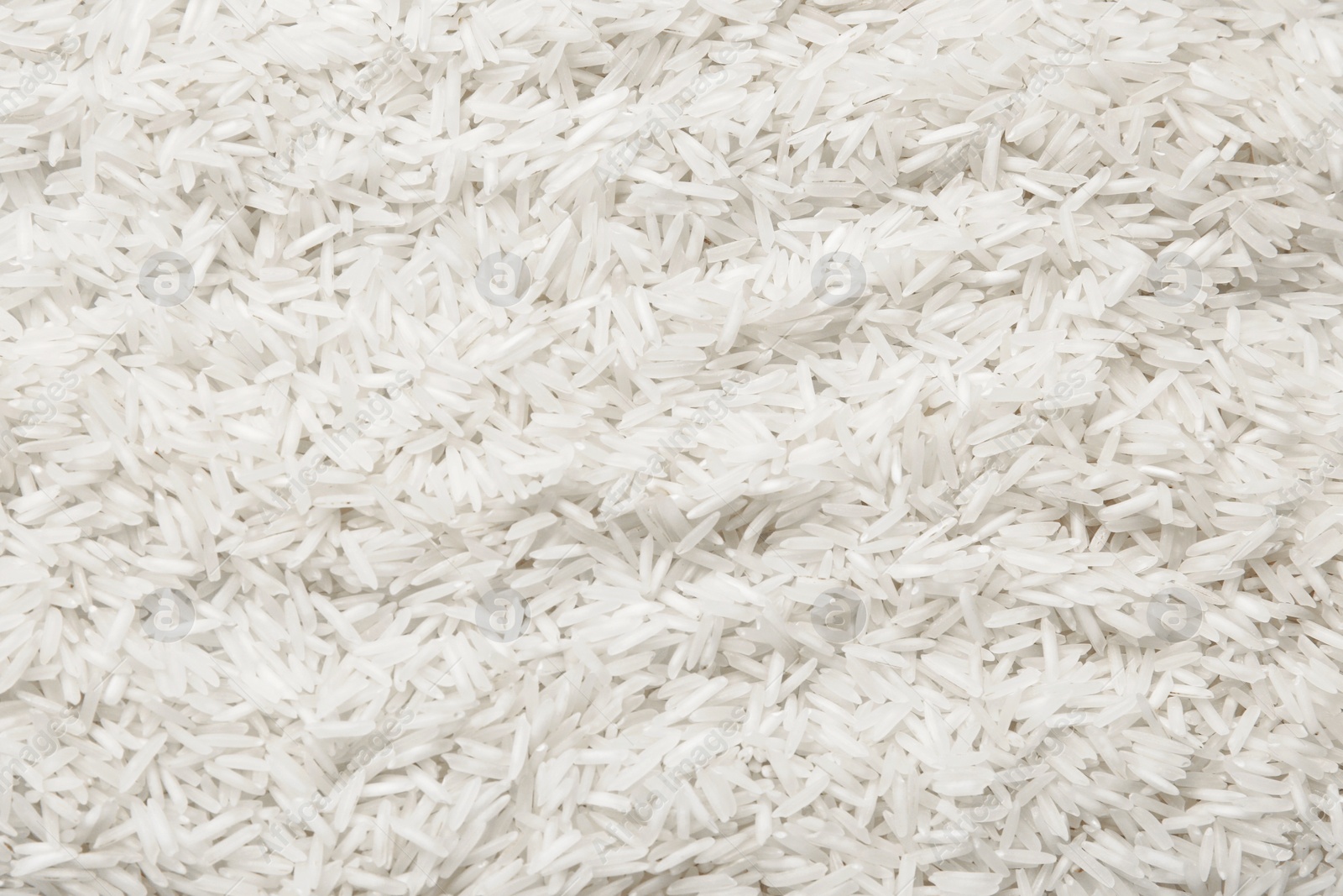 Photo of Raw basmati rice as background, top view