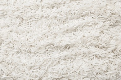 Photo of Raw basmati rice as background, top view