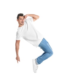 Photo of Young man in stylish jeans jumping on white background