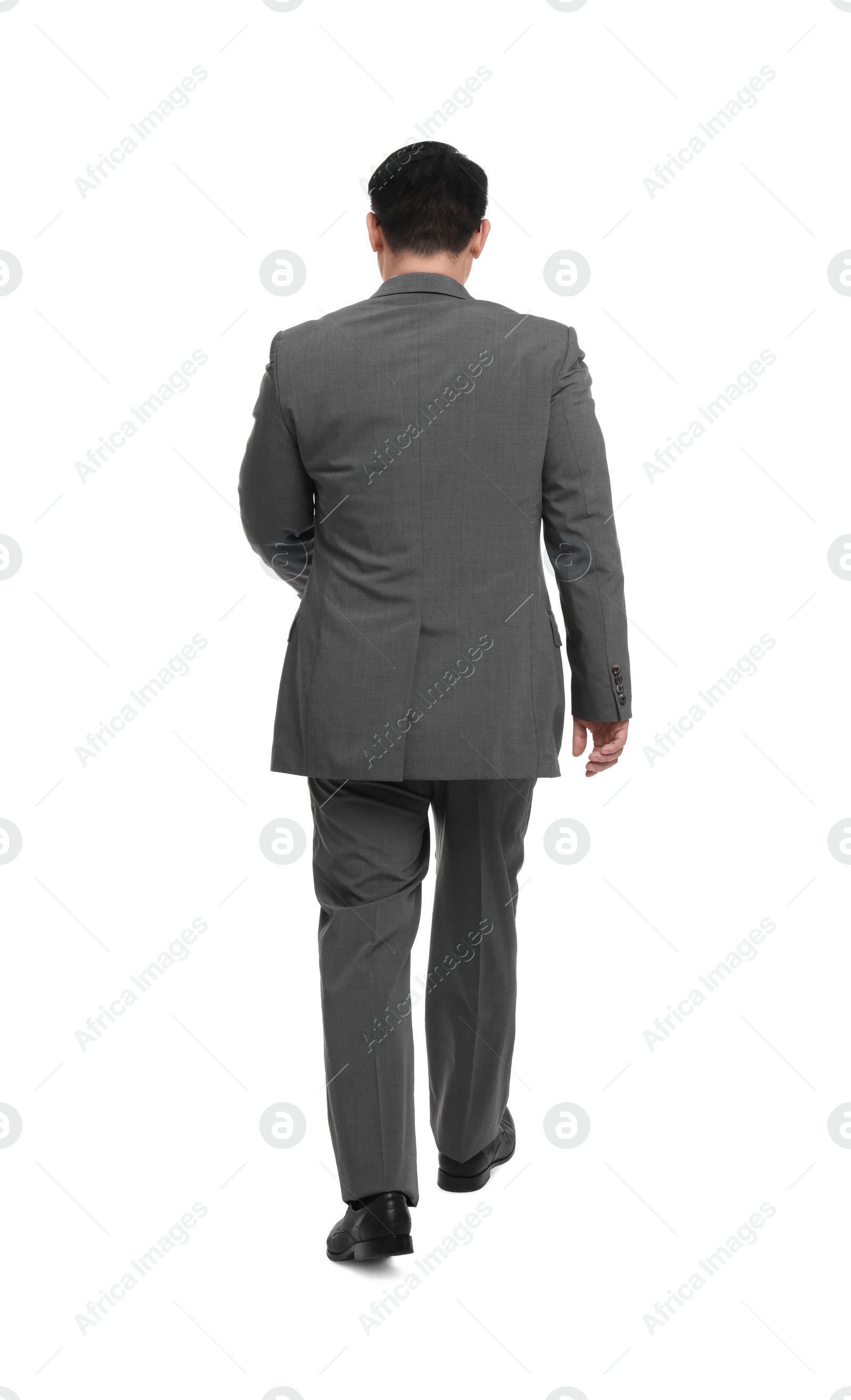 Photo of Businessman in suit walking on white background, back view