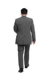 Photo of Businessman in suit walking on white background, back view