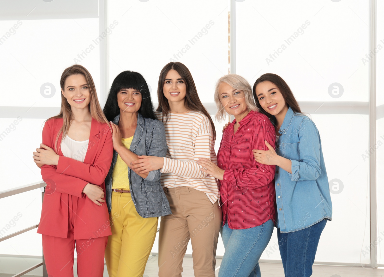 Photo of Group of ladies near window indoors. Women power concept