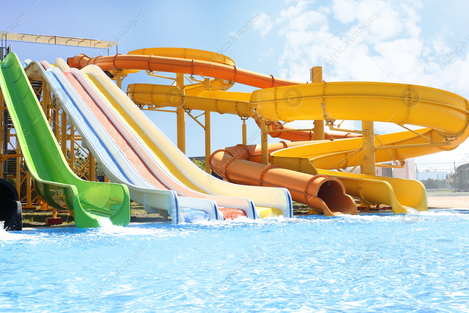 Photo of Different colorful slides in water park on sunny day