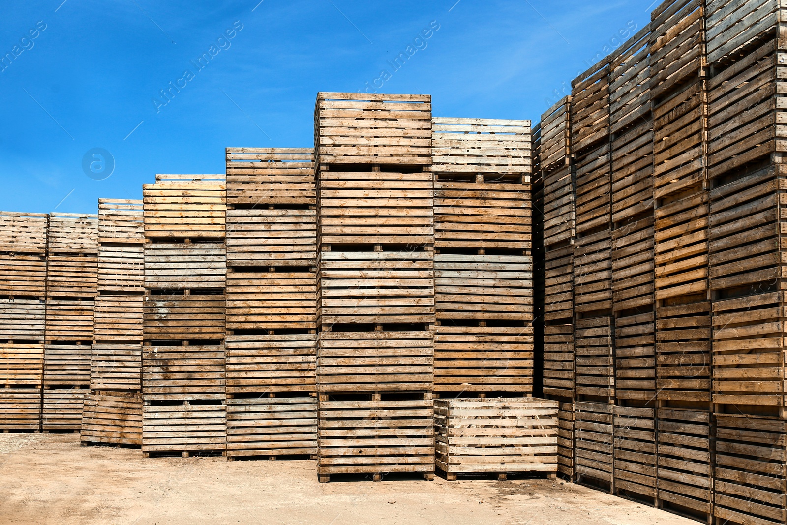 Photo of Pile of empty wooden crates outdoors on sunny day