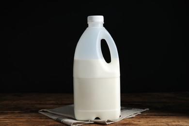 Photo of Gallon bottle of milk and napkin on wooden table