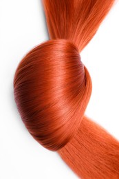 Photo of Beautiful strand of red hair tied in knot on white background, top view