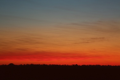 Photo of Picturesque view of beautiful sky lit by setting sun