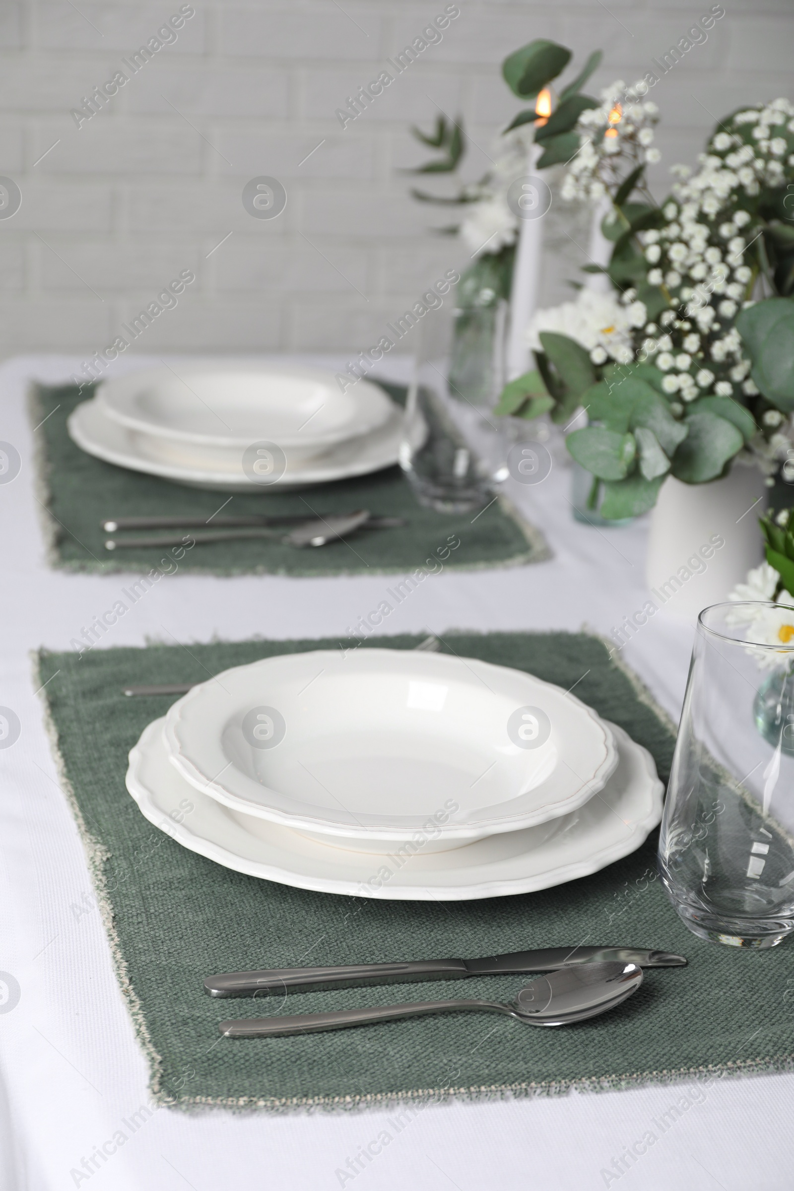Photo of Elegant festive setting with floral decor on table