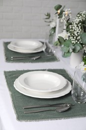 Photo of Elegant festive setting with floral decor on table