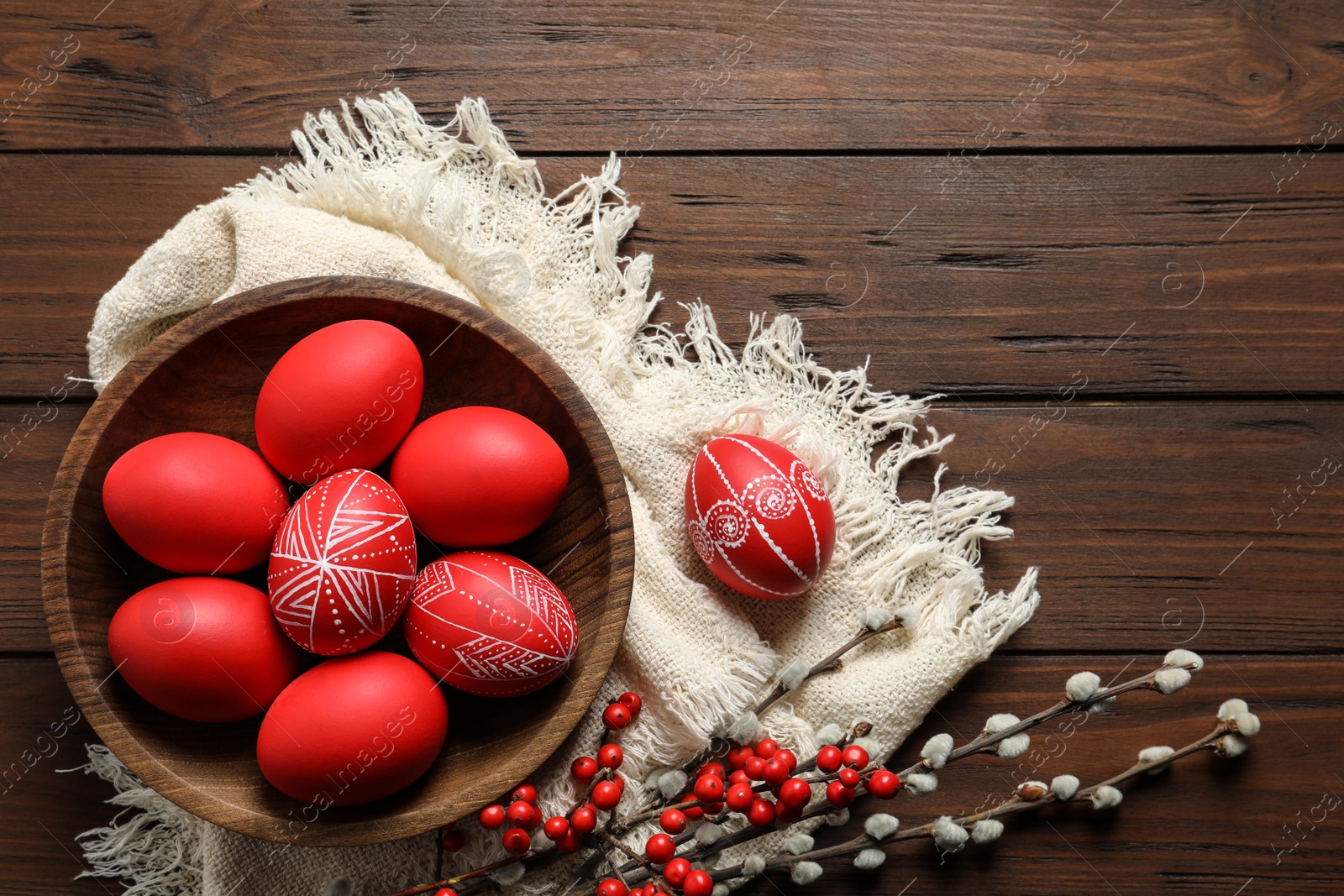 Photo of Flat lay composition with painted red Easter eggs on wooden table, space for text