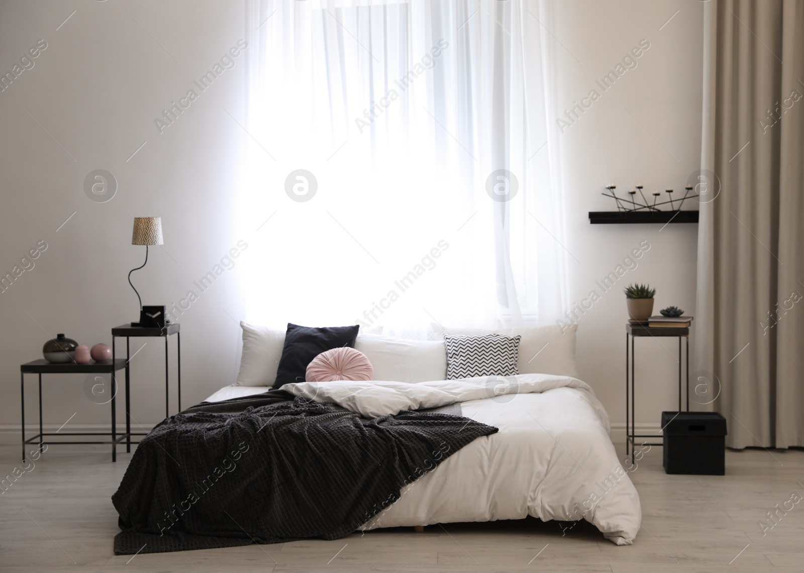 Photo of Stylish room interior with big comfortable bed