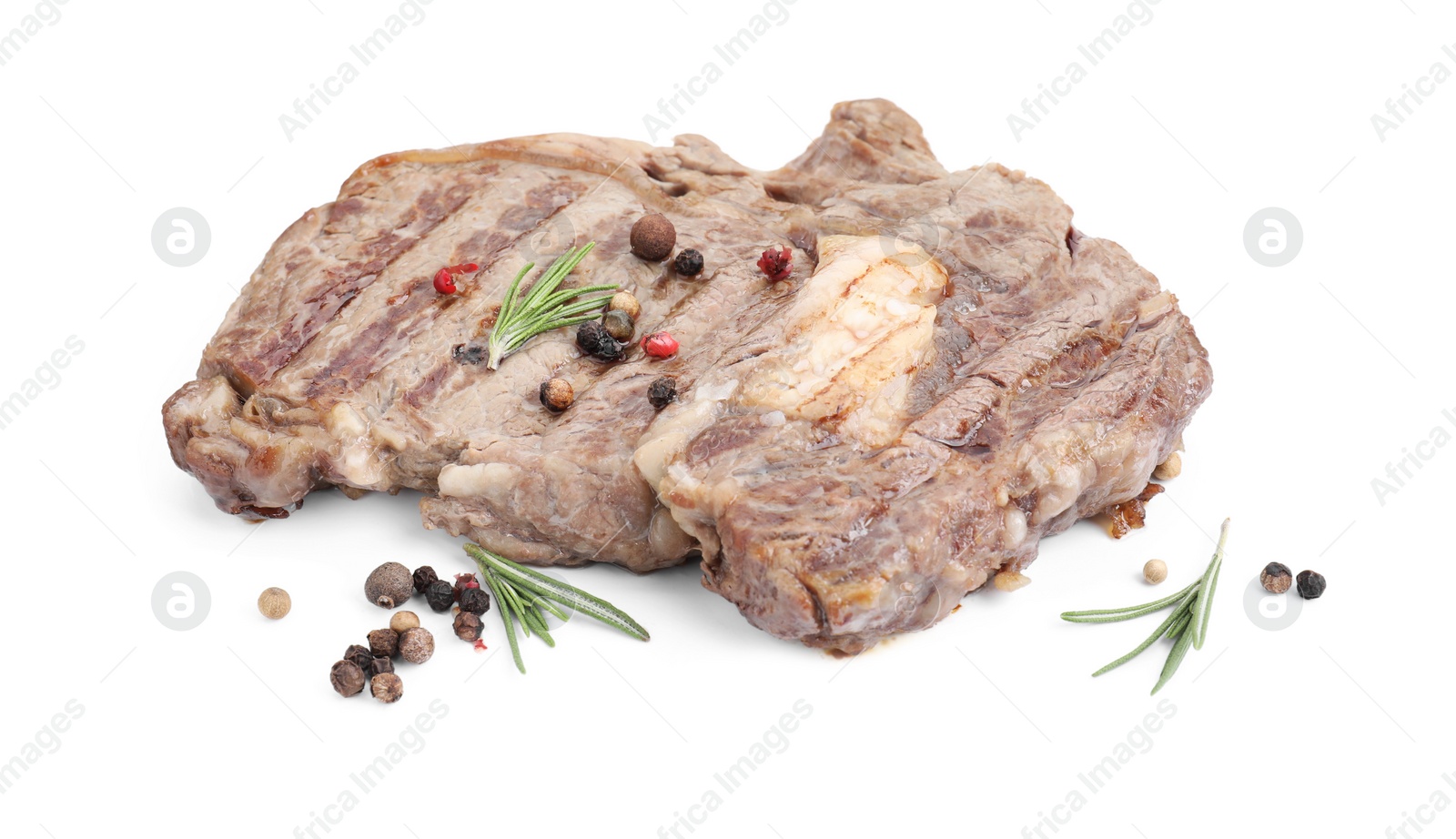 Photo of Piece of delicious grilled beef meat, rosemary and peppercorns isolated on white