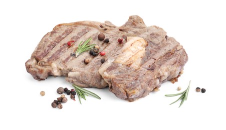 Piece of delicious grilled beef meat, rosemary and peppercorns isolated on white
