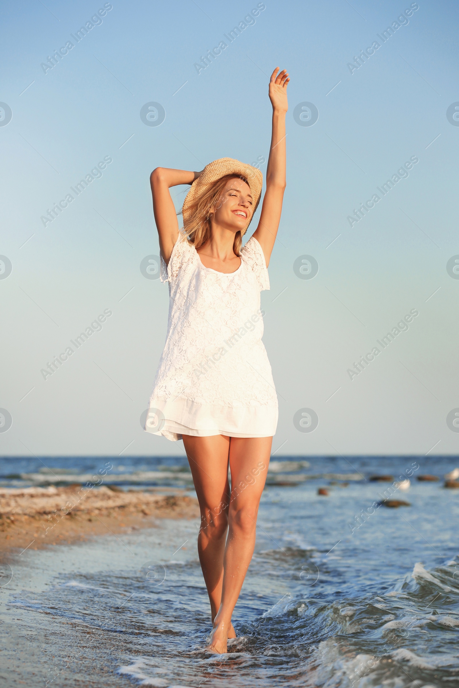 Photo of Young woman enjoying sunny day on beach