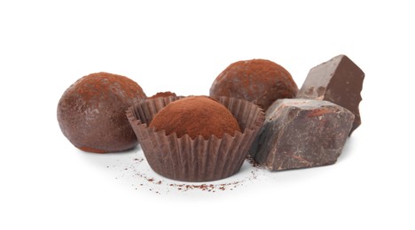 Photo of Delicious truffles with cocoa powder and chocolate on white background