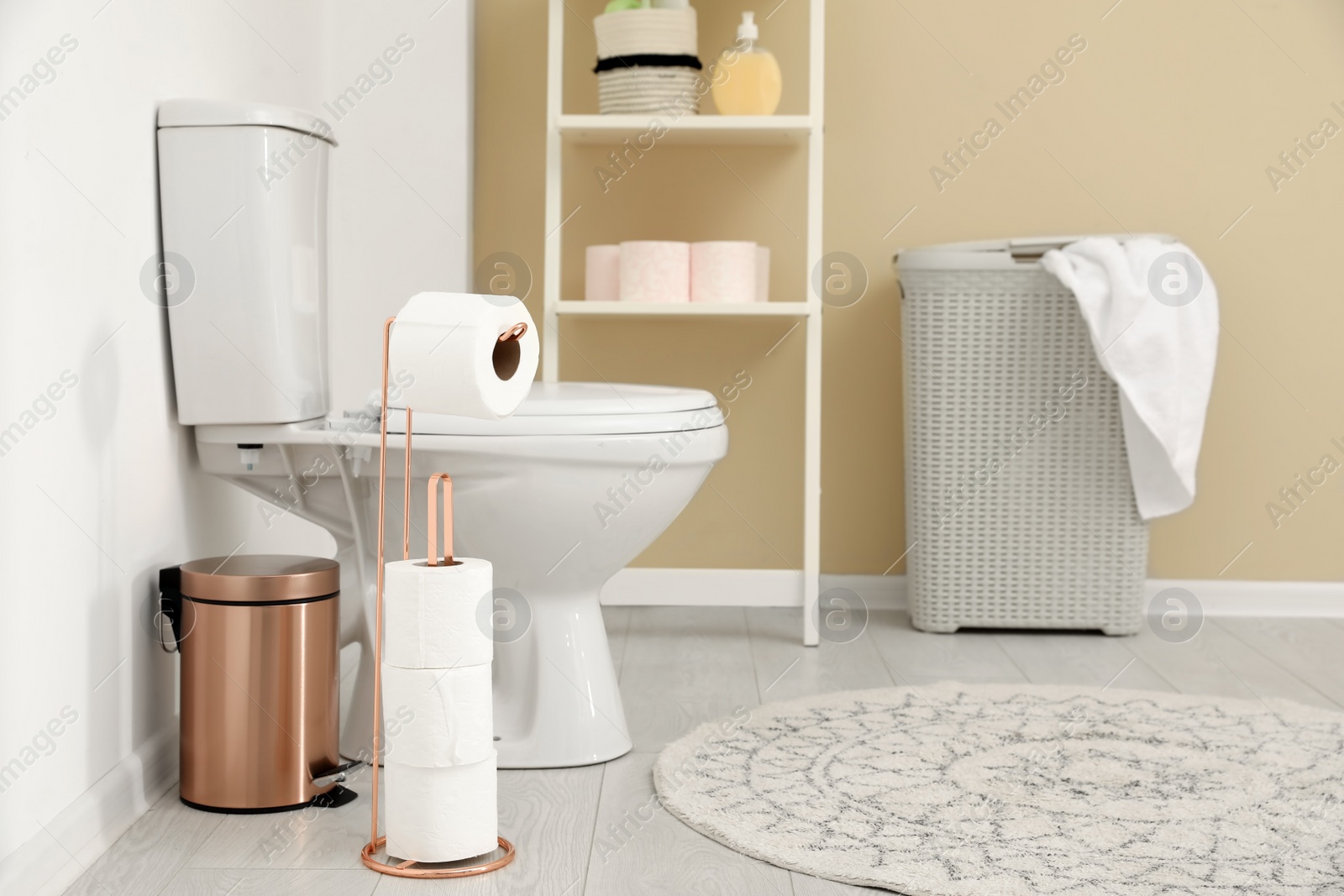 Photo of Holder with toilet paper rolls in bathroom