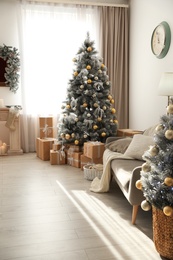 Photo of Stylish Christmas interior with beautiful decorated tree and gift boxes