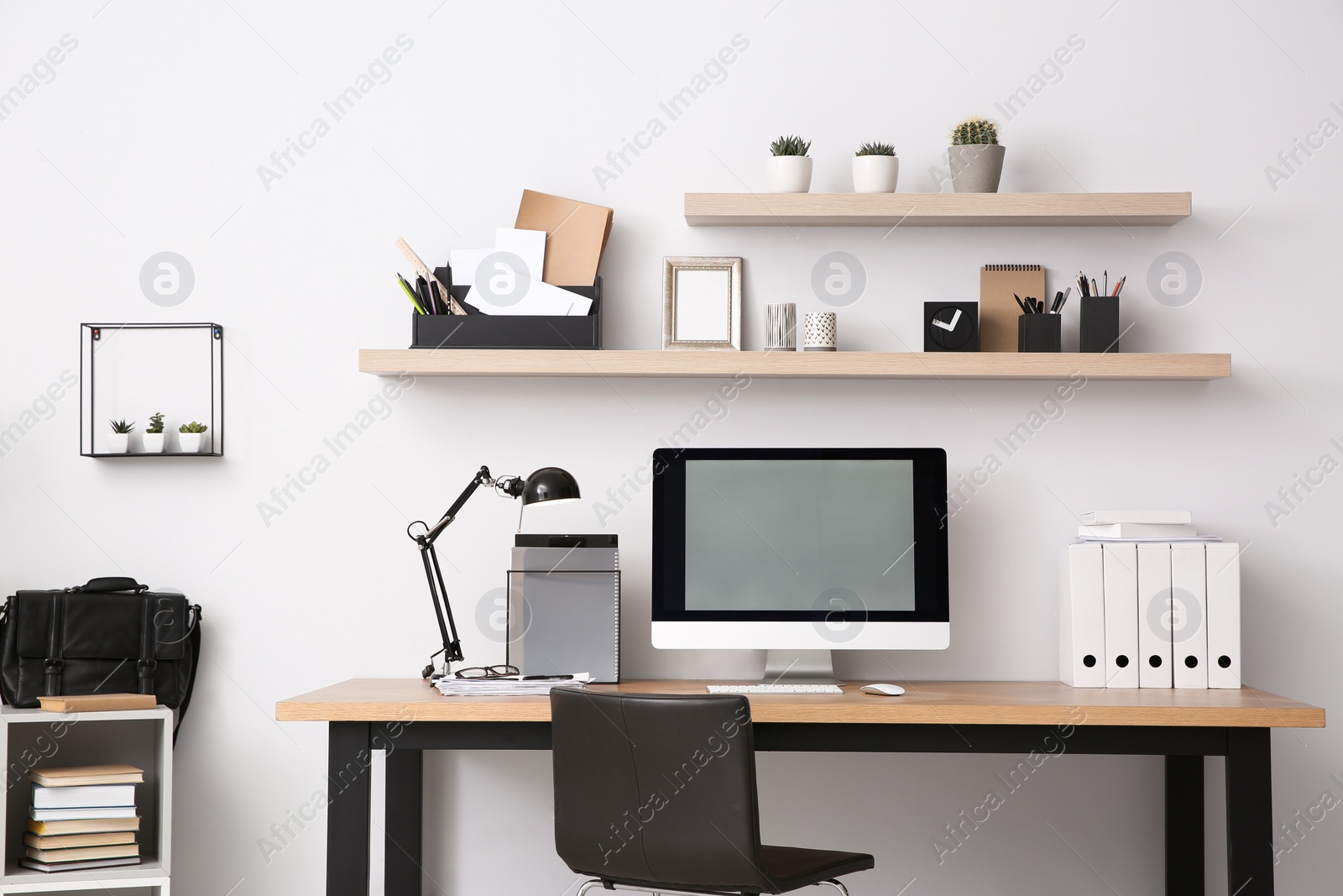 Photo of Modern computer on table in office interior. Stylish workplace