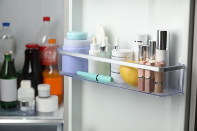 Different cosmetic products on shelves in refrigerator