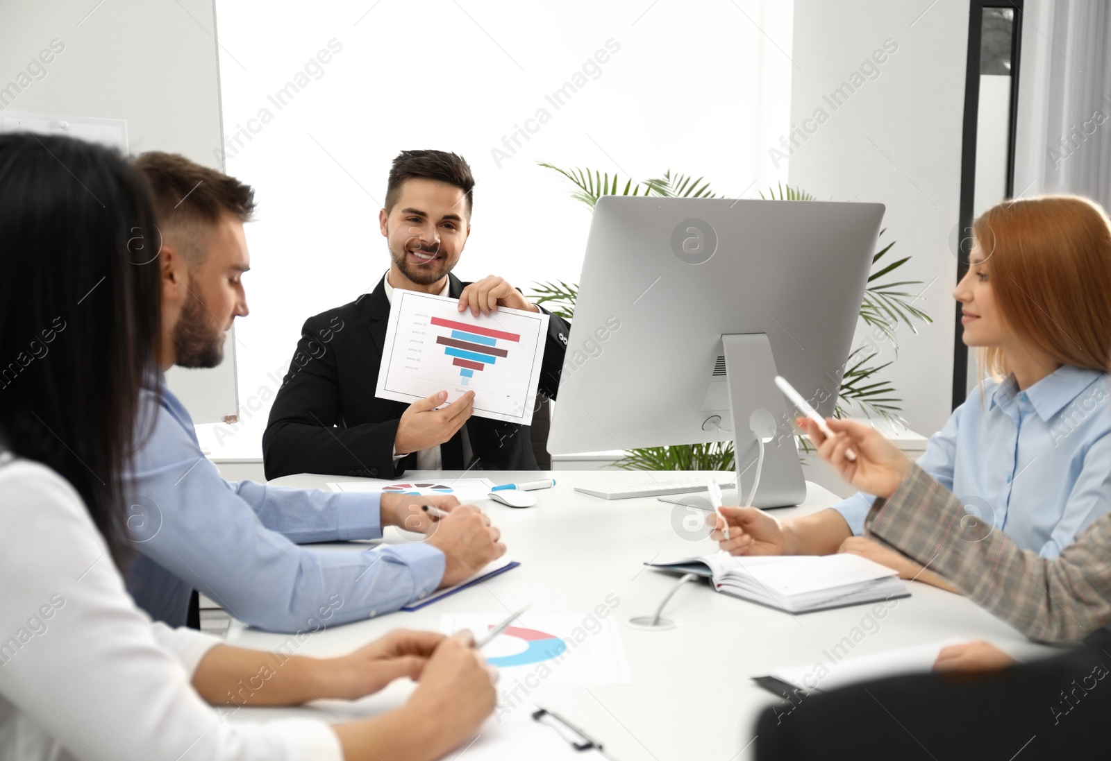 Photo of Professional business trainer working with people in office