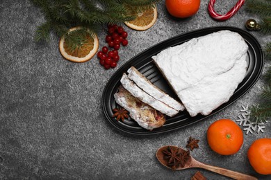 Traditional Christmas Stollen with icing sugar on grey table, flat lay. Space for text