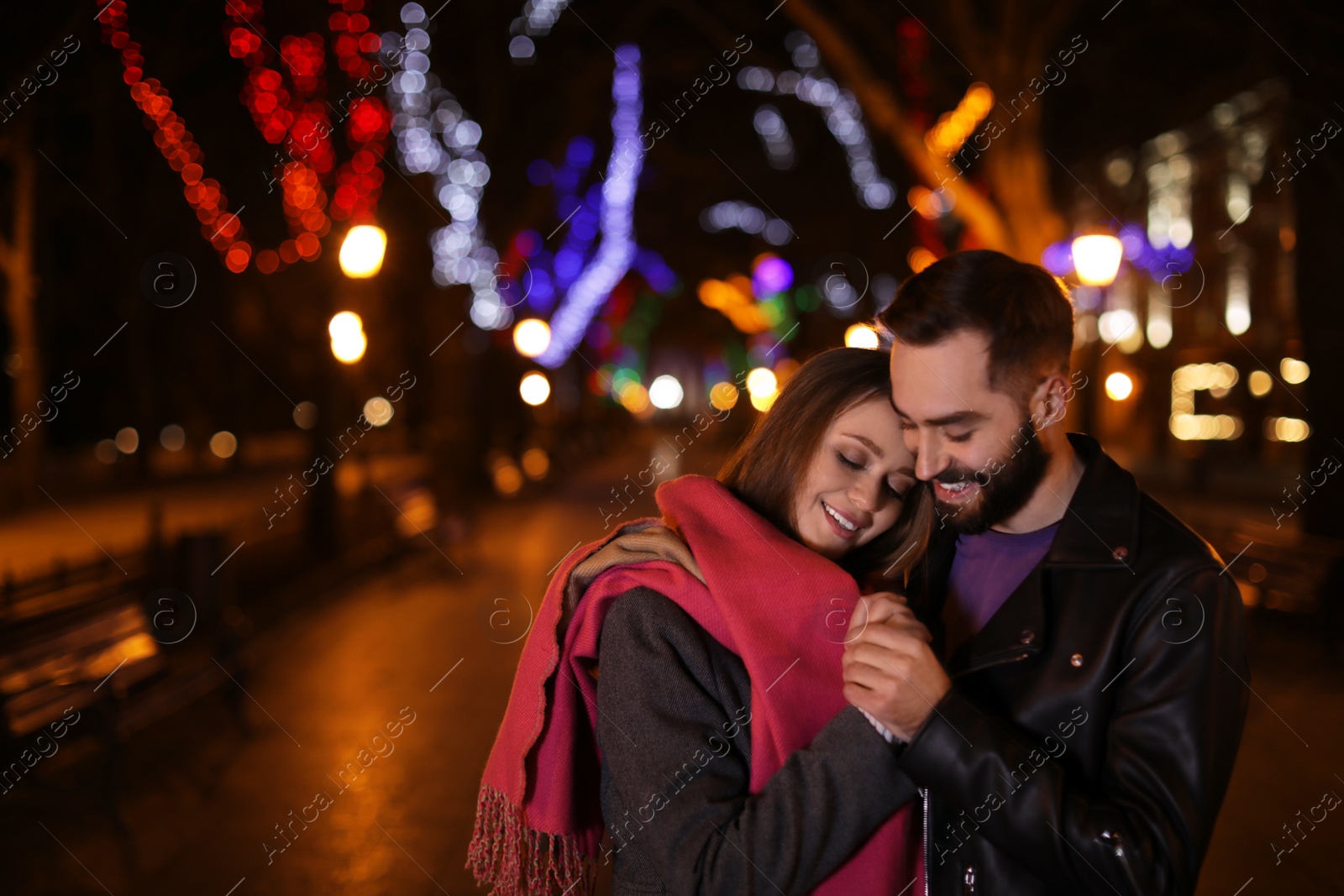 Photo of Lovely couple spending time in city at night