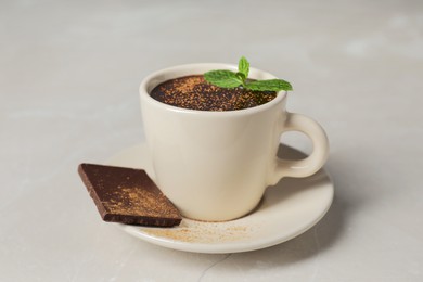 Photo of Cup of delicious hot chocolate with fresh mint on grey table, closeup