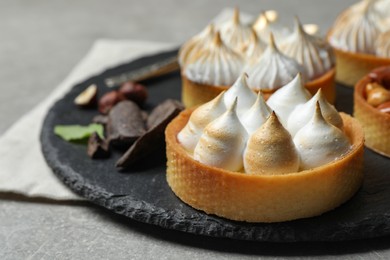 Photo of Different tartlets on grey table, closeup and space for text. Delicious dessert