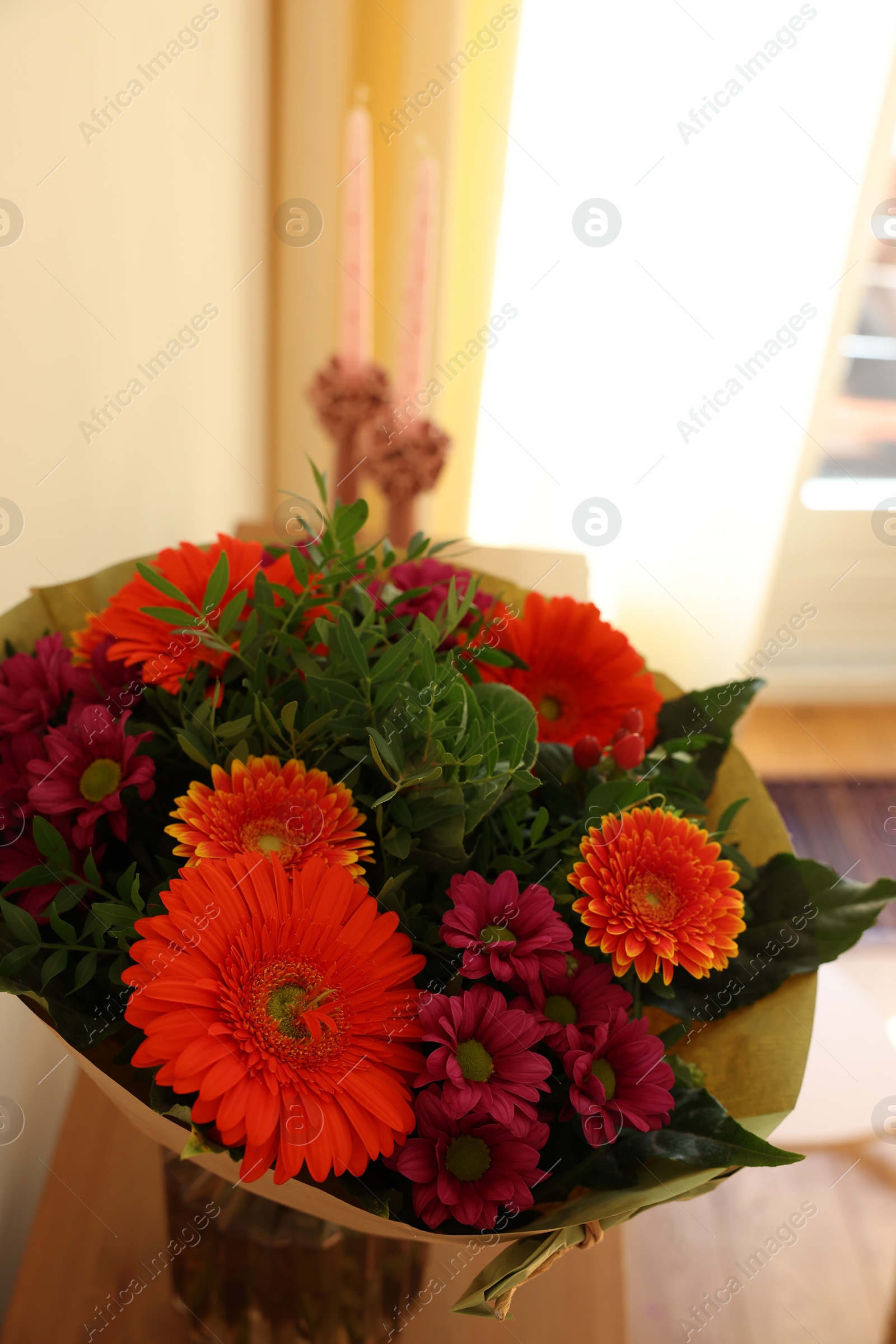 Photo of Bouquet of flowers on wooden table indoors, closeup