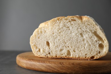 Photo of Freshly baked cut sourdough on grey table