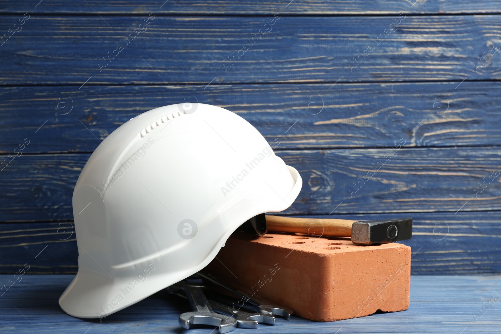 Photo of Composition with construction tools on table against wooden background