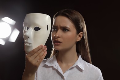 Photo of Professional actress with mask on stage in theatre